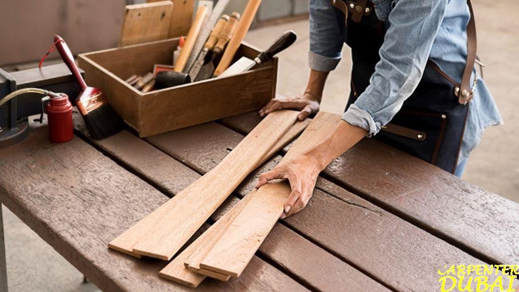 Carpenter preparing timber with hand tools
