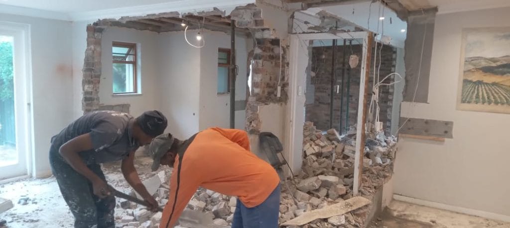Workers breaking out an internal wall inside a Cape Town home during a renovation