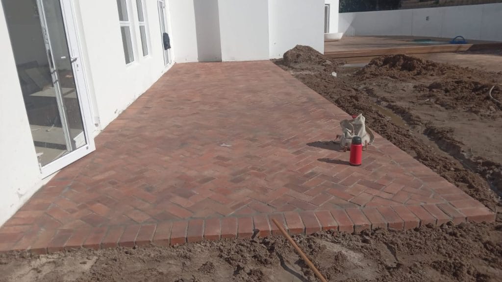Newly laid brick paving next to a white Cape Town house