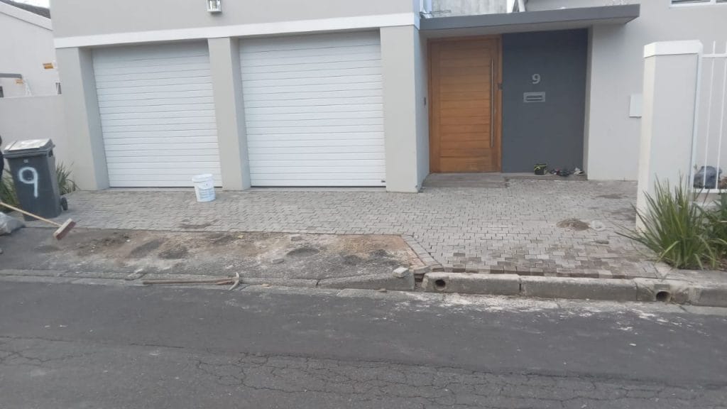 Double garage with white roller doors and a paved driveway in Cape Town