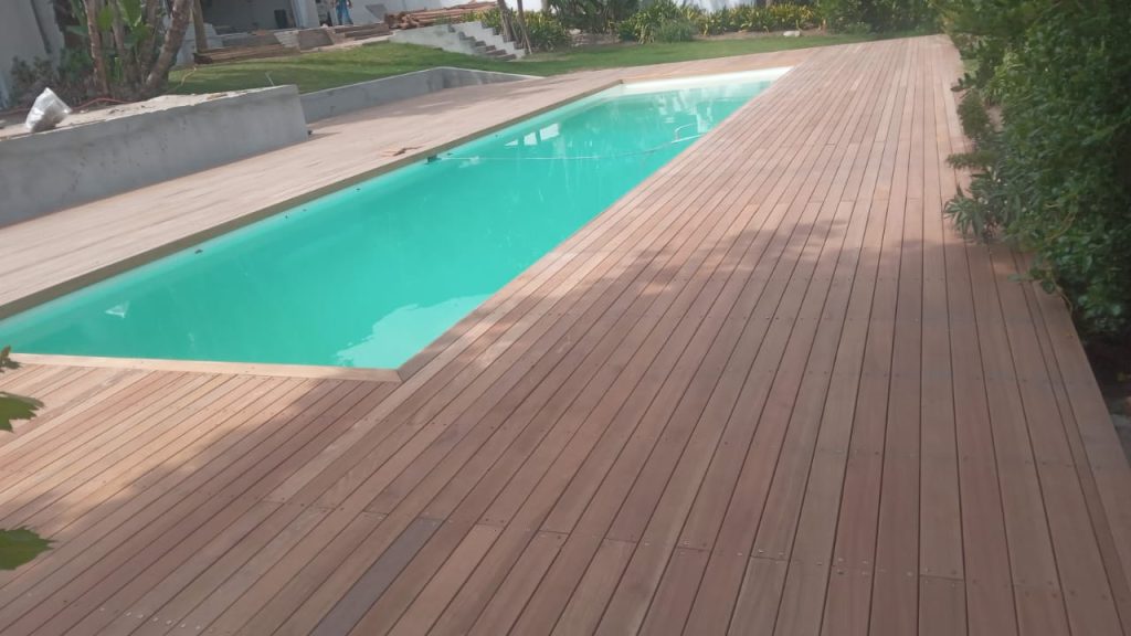 Pool with a wooden deck surround in Cape Town