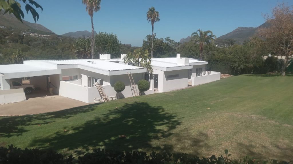 White estate home with a lawn in Cape Town