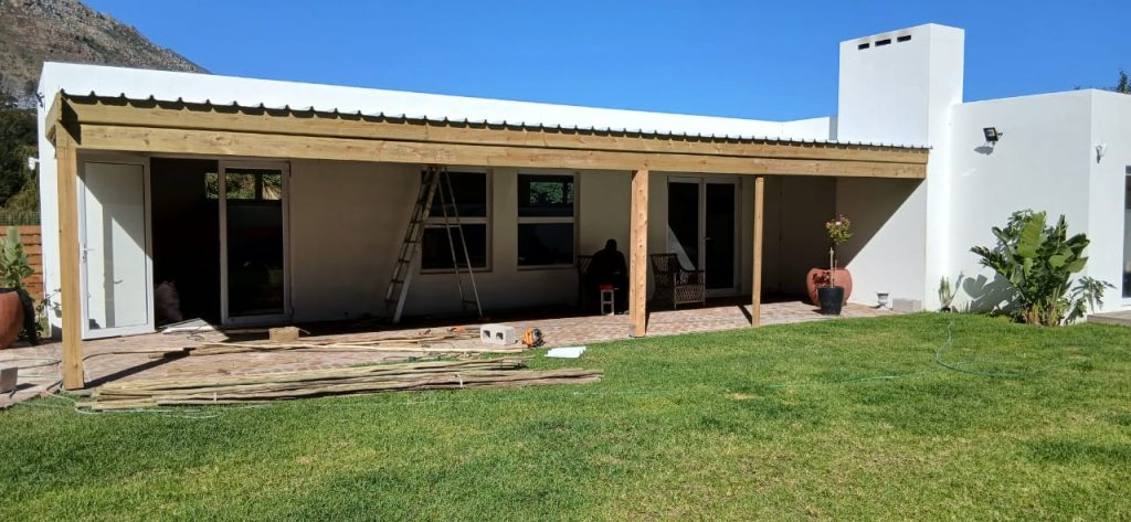 White home with a carport and lawn in Cape Town