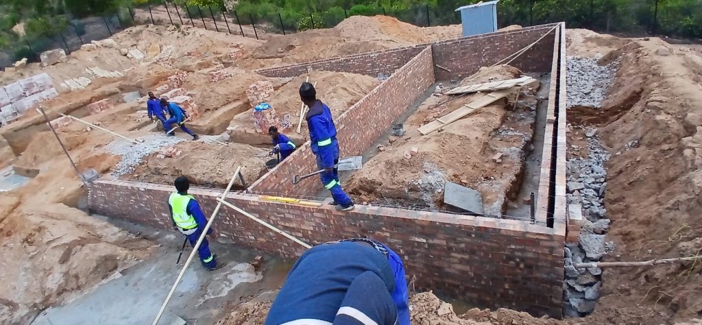 Builders working on foundation brickwork and footings on a Cape Town site
