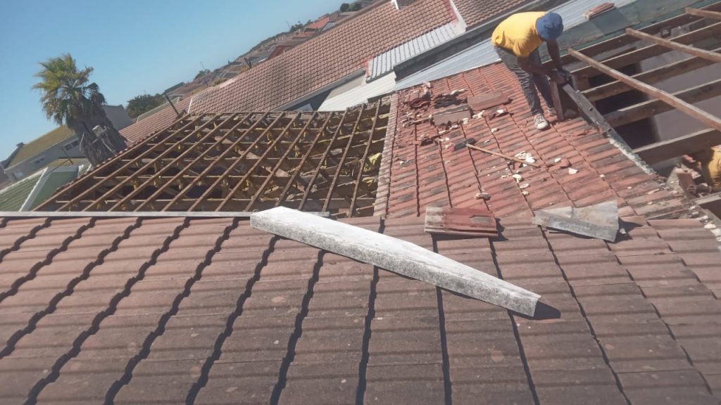 Roofer laying new roof tiles in Cape Town