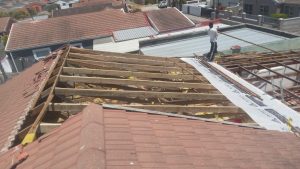 Tiled roof stripped back to timber battens for repair