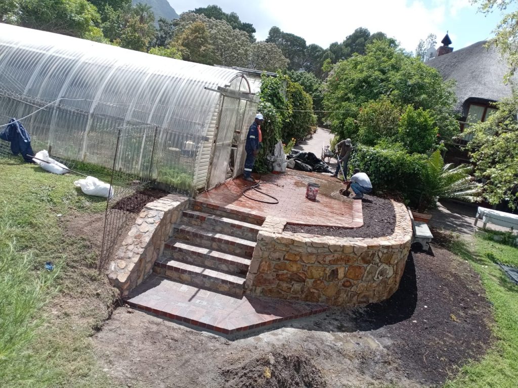 Stone wall, steps and greenhouse in Cape Town
