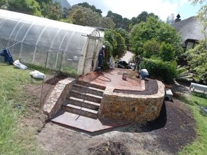 Stone wall, steps and greenhouse in Cape Town