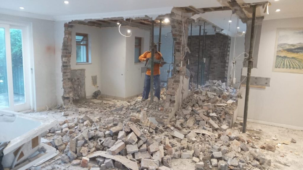 Internal wall being demolished with rubble cleared during a Cape Town renovation