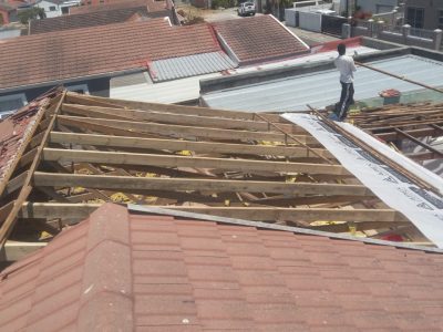 Tiled roof stripped back to timber battens for repair